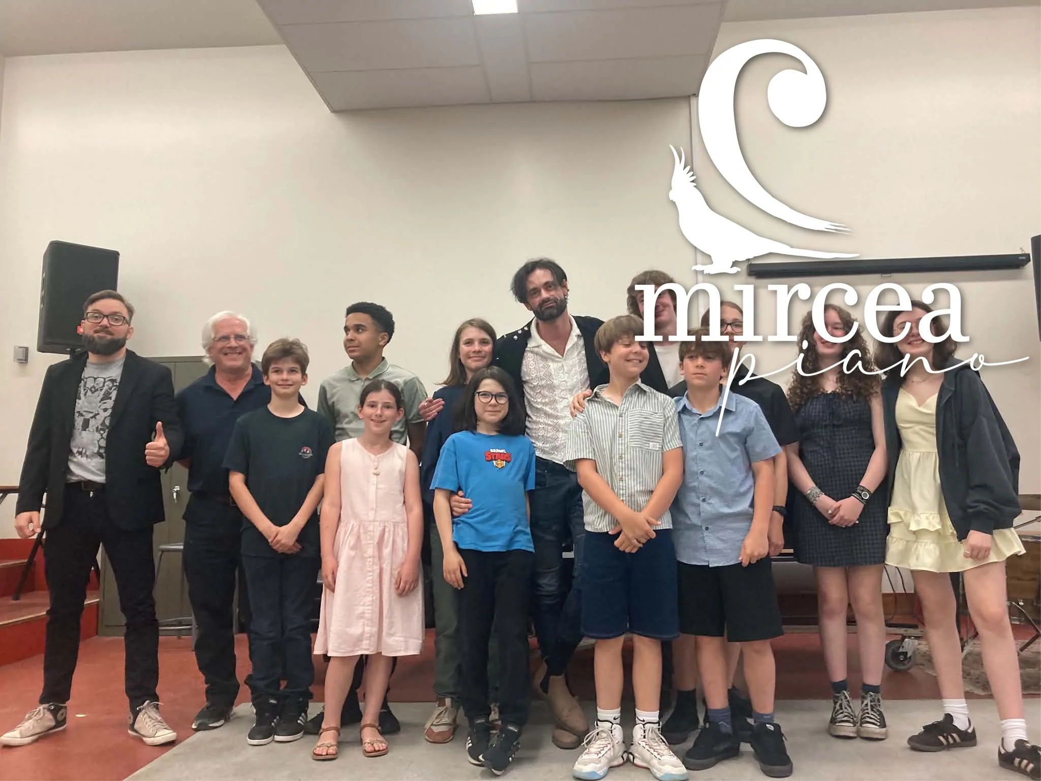 The whole group poses with Mircea after the June concert.
